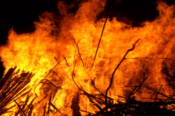 A yellow and orange inferno with a black sky backdrop